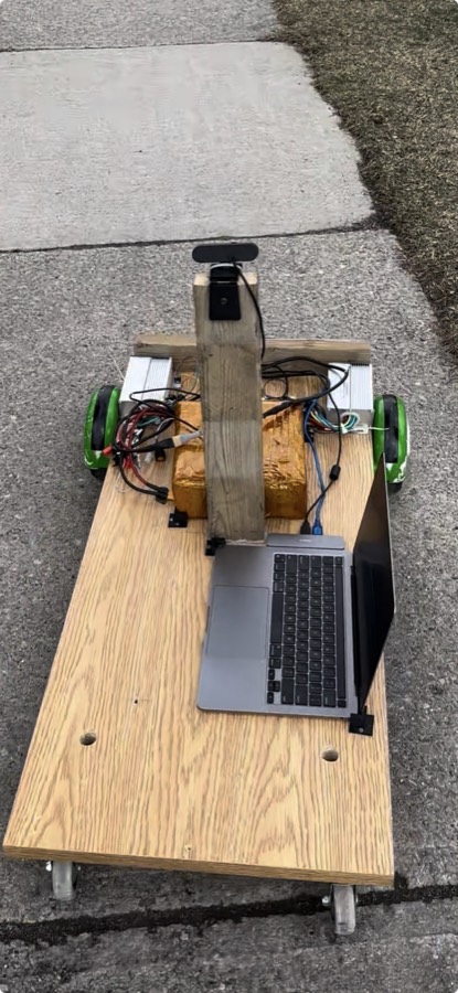 A wooden-chassis robot cart with a camera mast and laptop, built for the sidewalk-navigation project